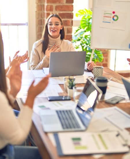 Group of business workers smiling happy and confident. Working together with smile on face applauding one of them at the office